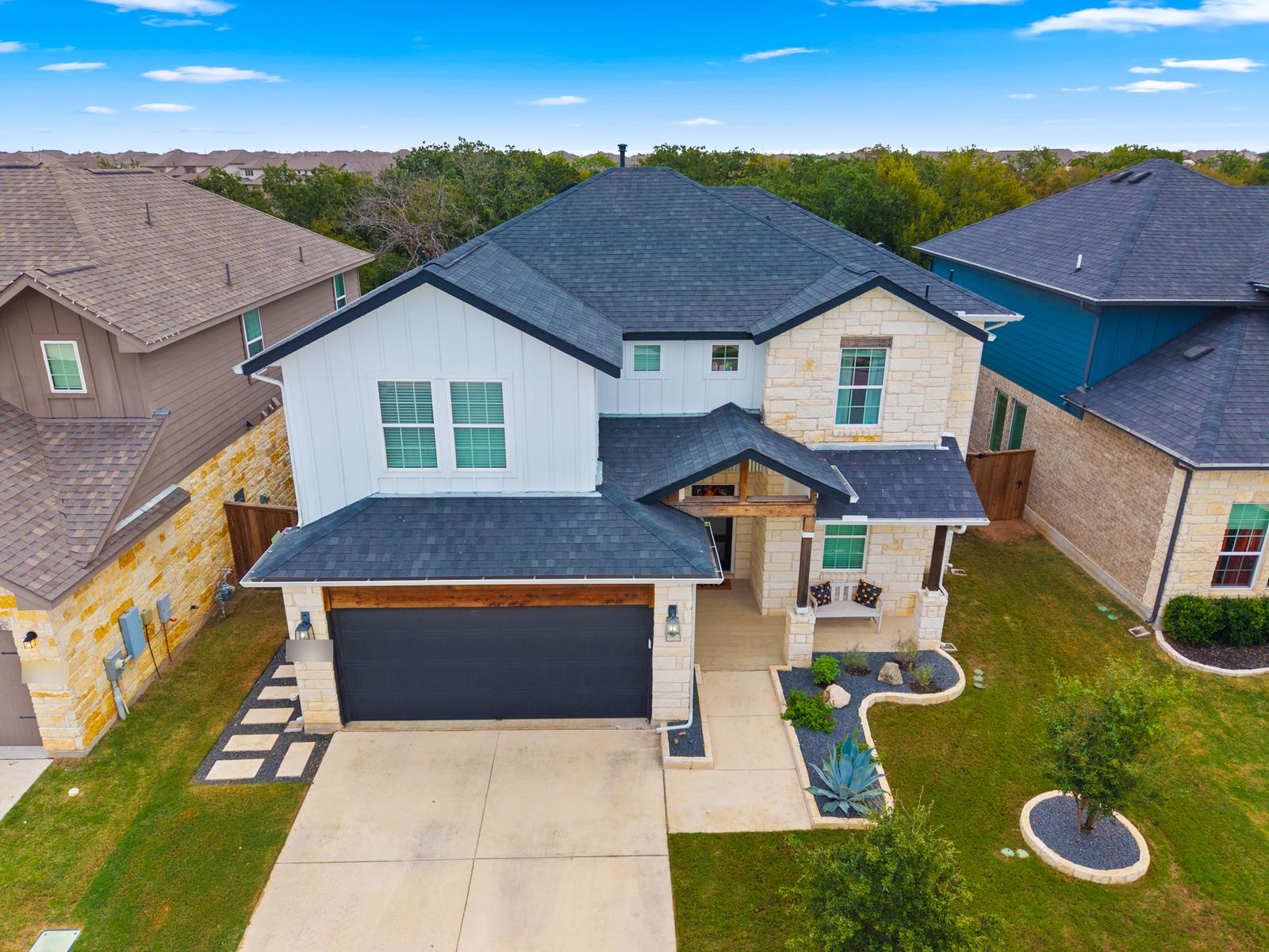 Aerial view of a two-story home in a Central Texas neighborhood